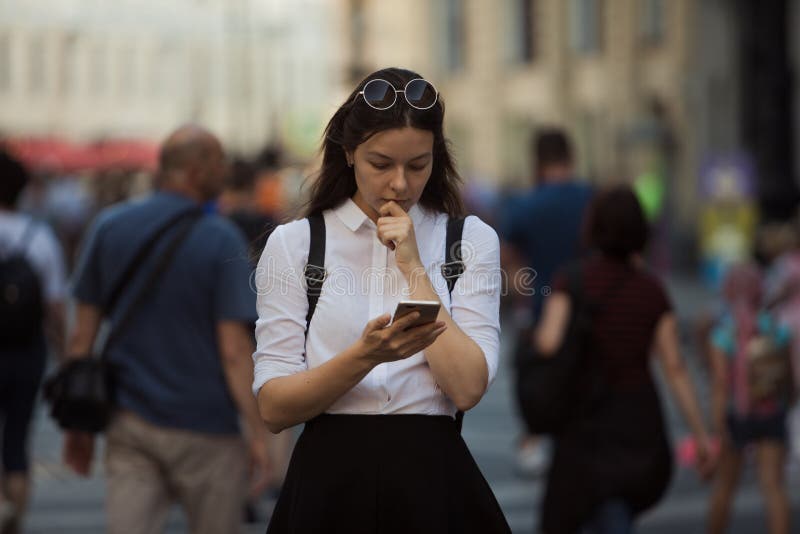 Girl on the street among the crowd of passers-by, photos in the style of surveillance