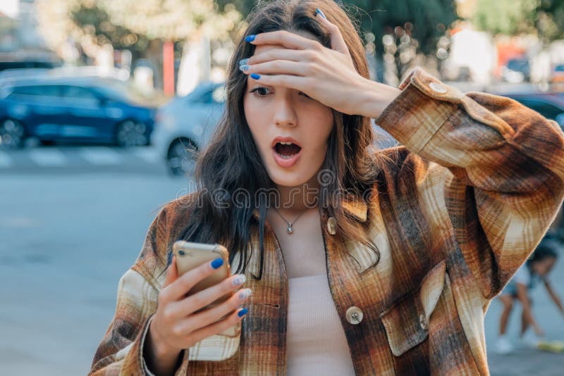 Girl In The Street Looking At The Mobile Phone Surprised Stock Image Image Of Holding Looking