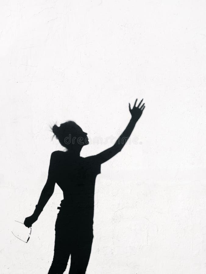 Girl Stretching Her Hand Toward Sky Around Wall Background Stock