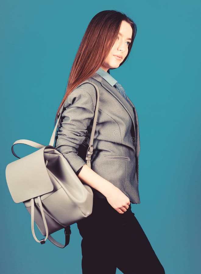 Girl student in formal clothes. Backpack fashion trend. Woman with leather knapsack. Stylish woman in jacket with royalty free stock photos Girl student in formal clothes. Backpack fashion trend. Woman with leather knapsack. Stylish woman in jacket with royalty free stock photos