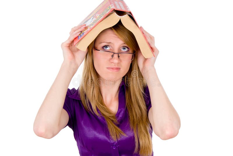 A girl student keep a dictionary on the head