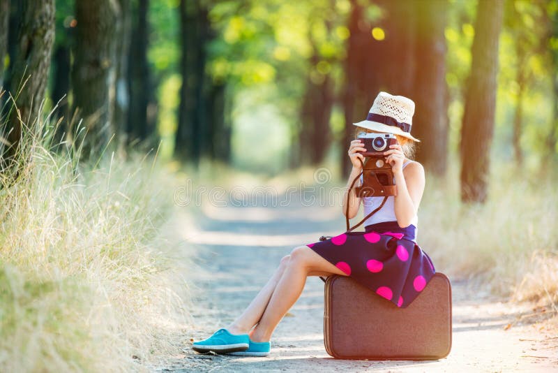 Girl with suitcase and camera