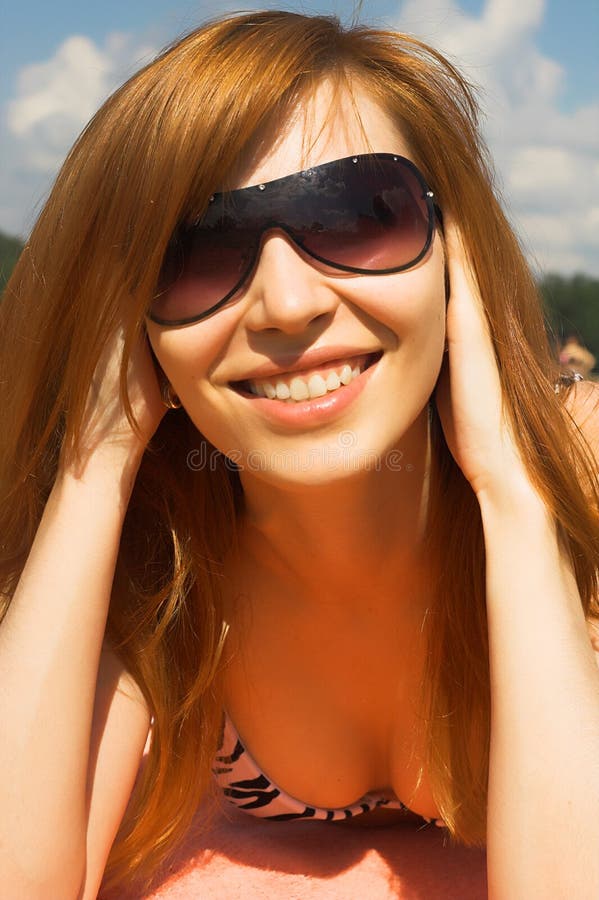 Girl in sunglasses on a beach