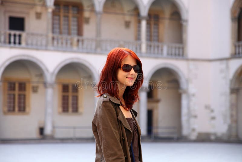 Girl in sunglasses at castle