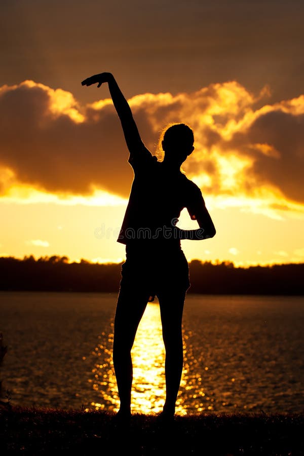 Girl gymnastics pose at sunset beach in orange sky, Stock Photo, Picture  And Low Budget Royalty Free Image. Pic. ESY-042863154 | agefotostock