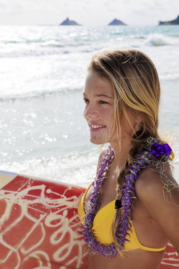 Girl with surfboard at kailua beach