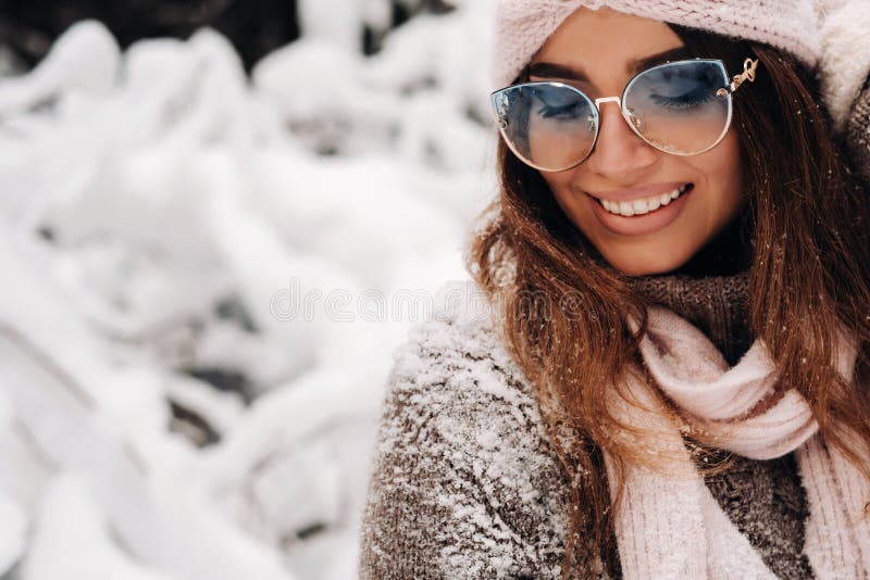 A Girl in a Sweater and Glasses in Winter in a Snow-covered Forest ...