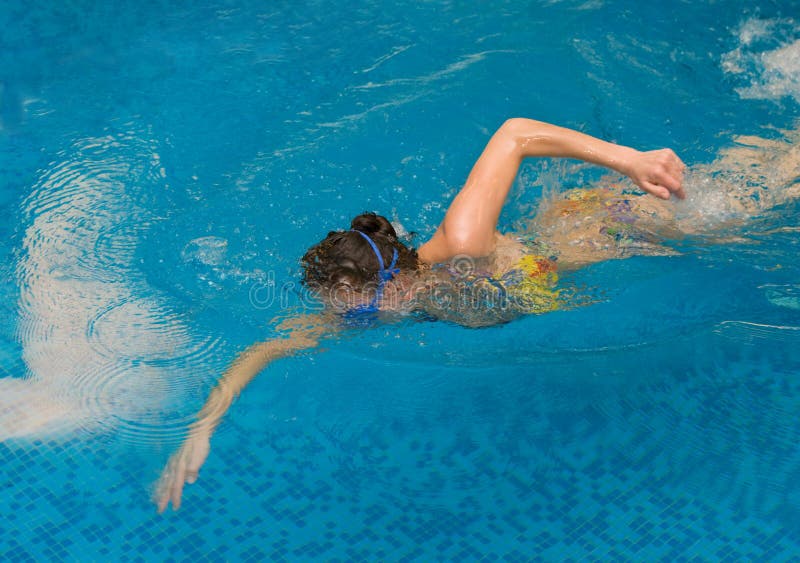 Girl swim in the swimming pool