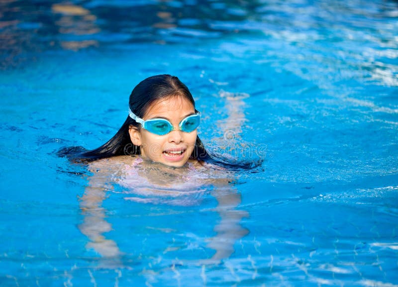 Young girl swimming in the pool