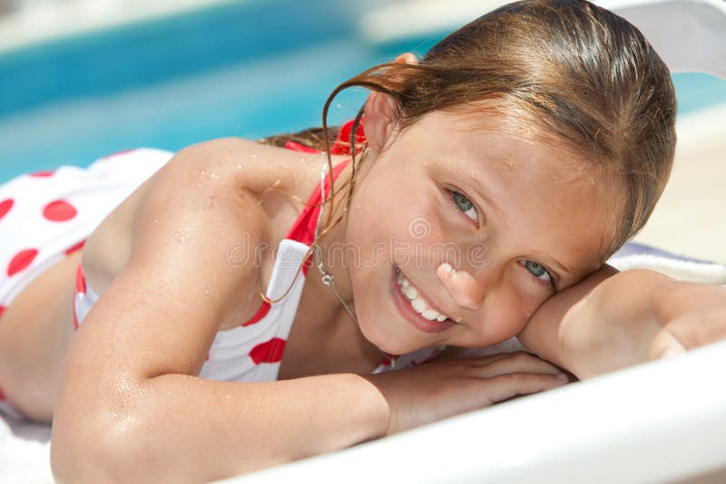 Girl by the swimming pool