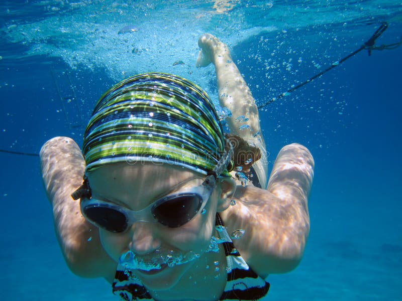 Portrait of young girl swimming in blue sea or ocean. Portrait of young girl swimming in blue sea or ocean.