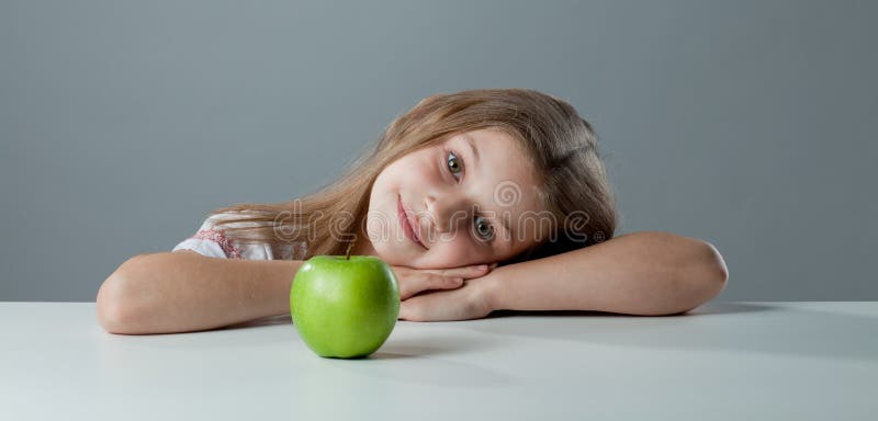 Girl at the table stock photography