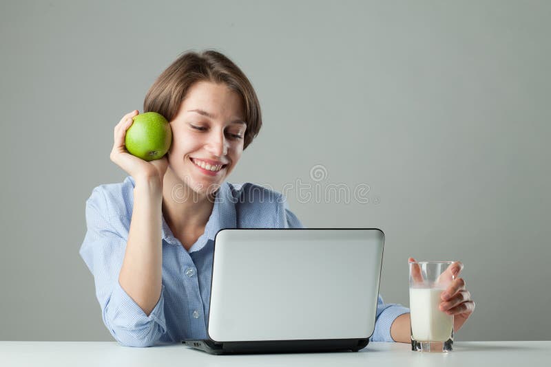 Girl at the table with a laptop royalty free stock images