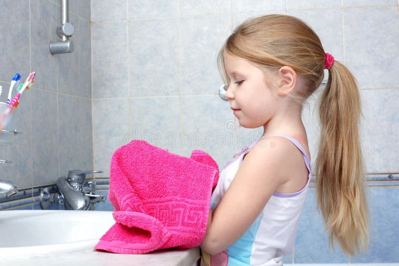 Girl taken towel after washing in bathroom