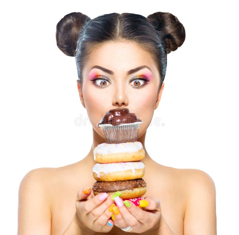Girl taking stack of colorful donuts and muffin royalty free stock images Girl taking stack of colorful donuts and muffin royalty free stock images