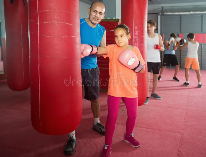 Girl teenager at boxing workout on punching bag stock photography Girl teenager at boxing workout on punching bag stock photography