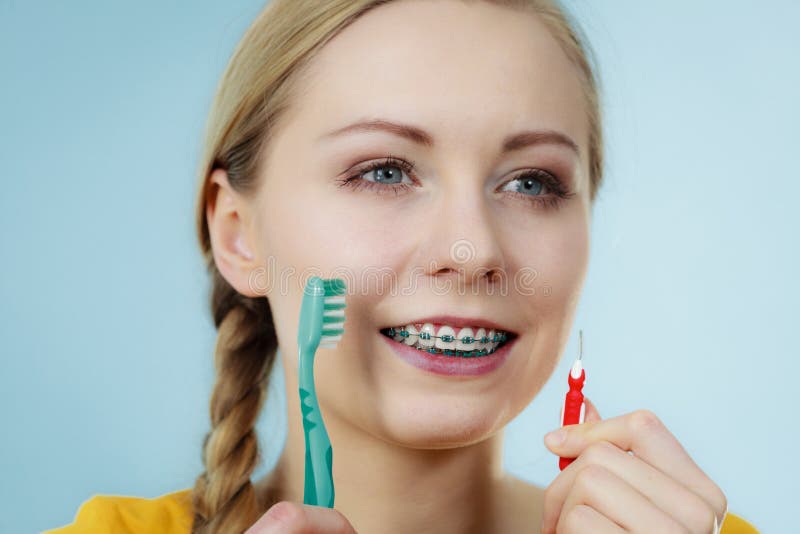 Girl With Teeth Braces Using Interdental And Traditional Brush S