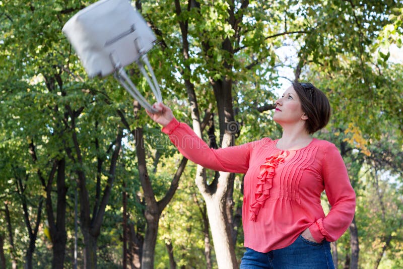 Girl Throwing Her Bag in the Air in a Park Stock Image Image of
