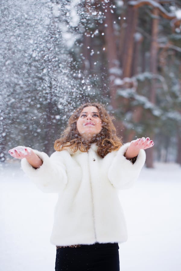 The girl throws up snow stock image. Image of cute, coat - 264191961