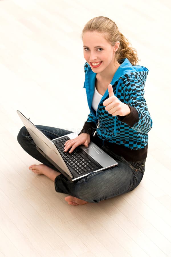 Girl with thumbs up using laptop royalty free stock images