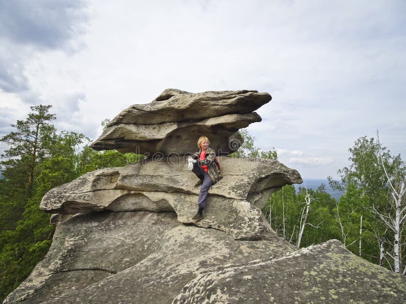A girl on top of a mountain, in the background of a panorama of mountains and lakes. The girl is happy with height stock image A girl on top of a mountain, in the background of a panorama of mountains and lakes. The girl is happy with height stock image