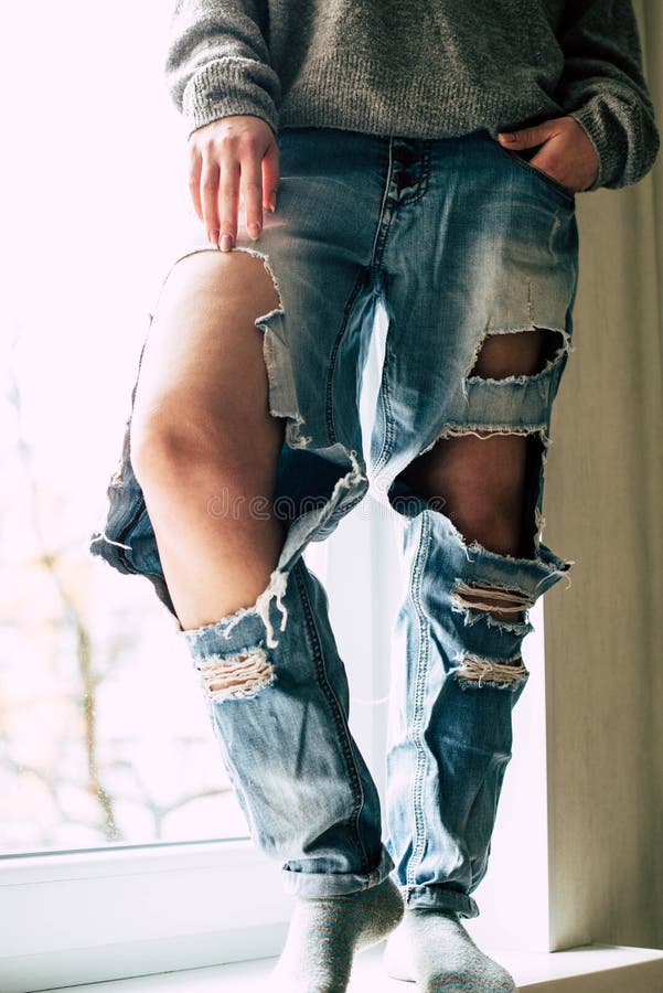 Torn jeans on the girl stock image. Image of posing - 148162887