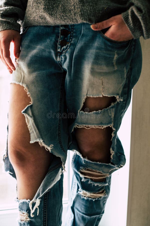 Torn jeans on the girl stock image. Image of posing - 148162887