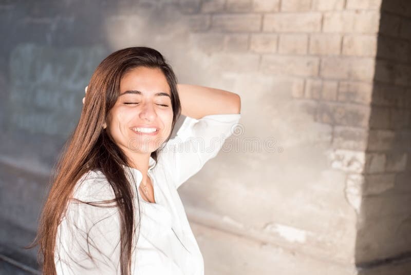 Profile of Indian woman smiling and touching her hair Stock Photo - Alamy