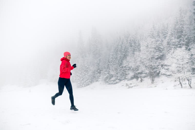 Girl trail running on snow in winter mountains royalty free stock image Girl trail running on snow in winter mountains royalty free stock image