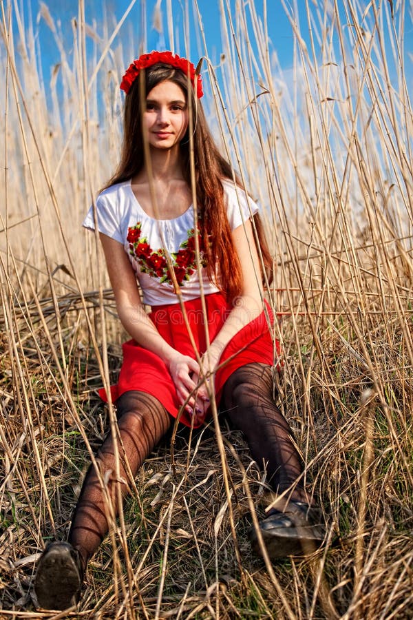 Girl In Ukrainian National Costume Smiling Sitting In The Reeds Stock