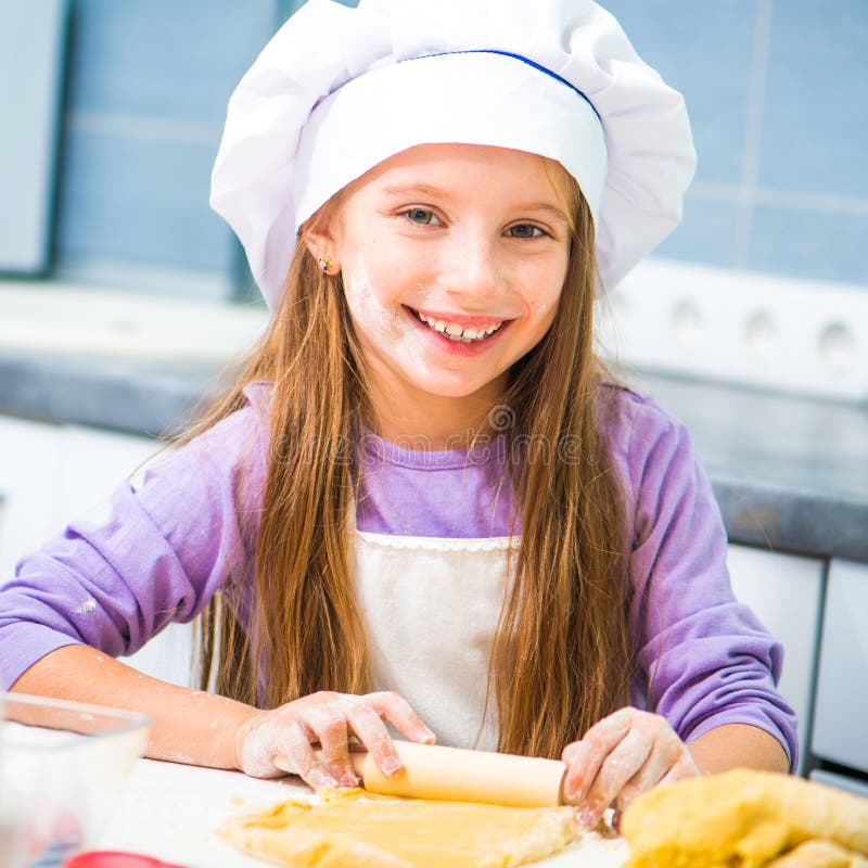 Girl unrolls cookie dough