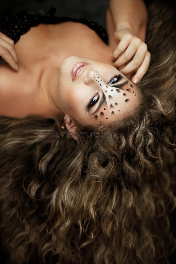 Girl with an unusual make-up as a leopard