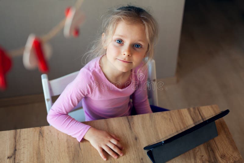 Girl Uses a Tablet for a Game and Smiles, Laughs. Child Using Gadgets ...