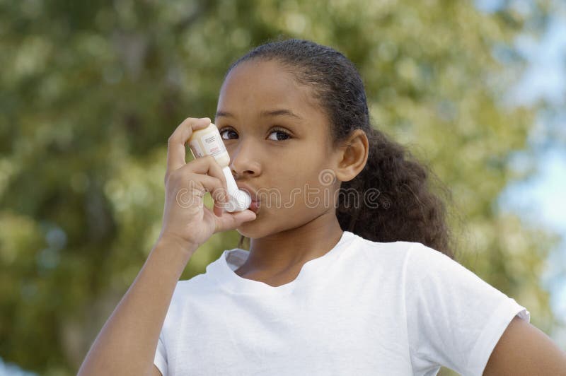 Girl Using Asthma Inhaler royalty free stock images