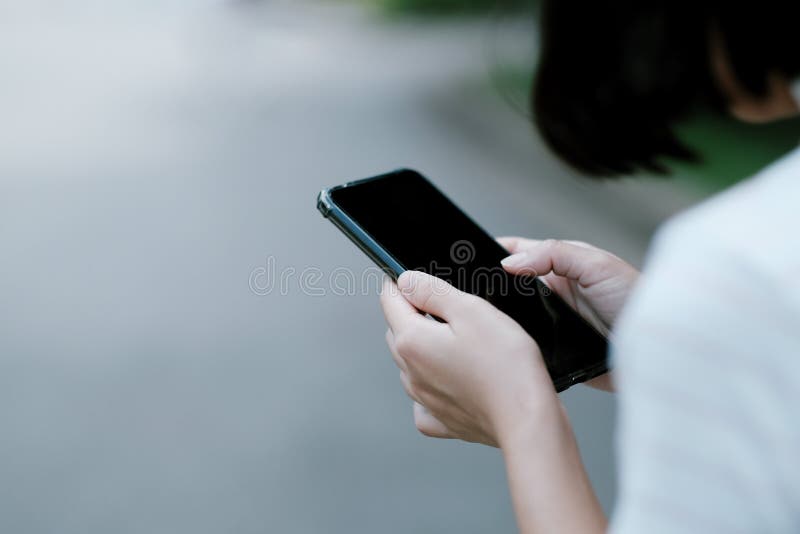 A girl using black smartphone for online shopping stock photo A girl using black smartphone for online shopping stock photo