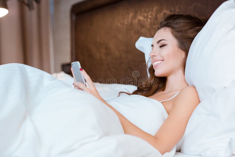 Girl Using Cellphone Lying In Bed Stock Image Image Of Comfort Female 61752957