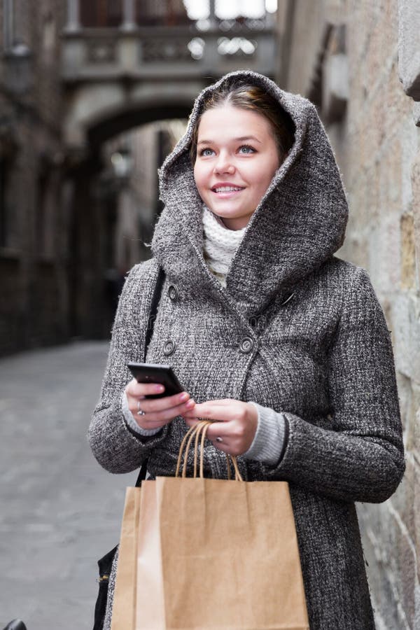 Girl using mobile phone at the street stock photos Girl using mobile phone at the street stock photos