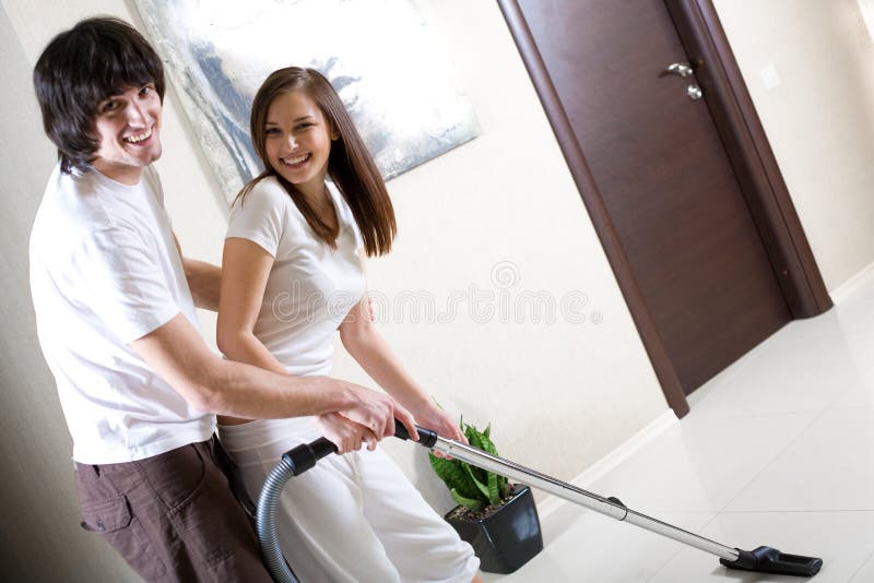 Girl with vacuum cleaner and boy with smile