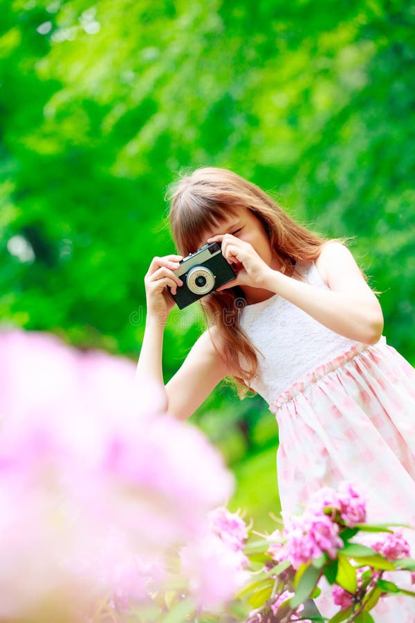 Girl with vintage camera making images