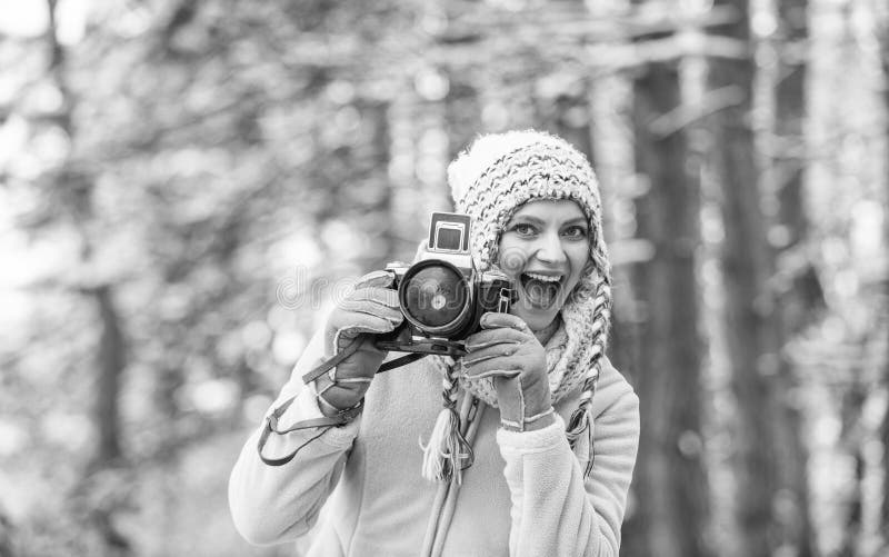 Girl with vintage camera in snowy nature. Traveling concept. Capturing winter. Take stunning winter photos. Winter hobby stock image