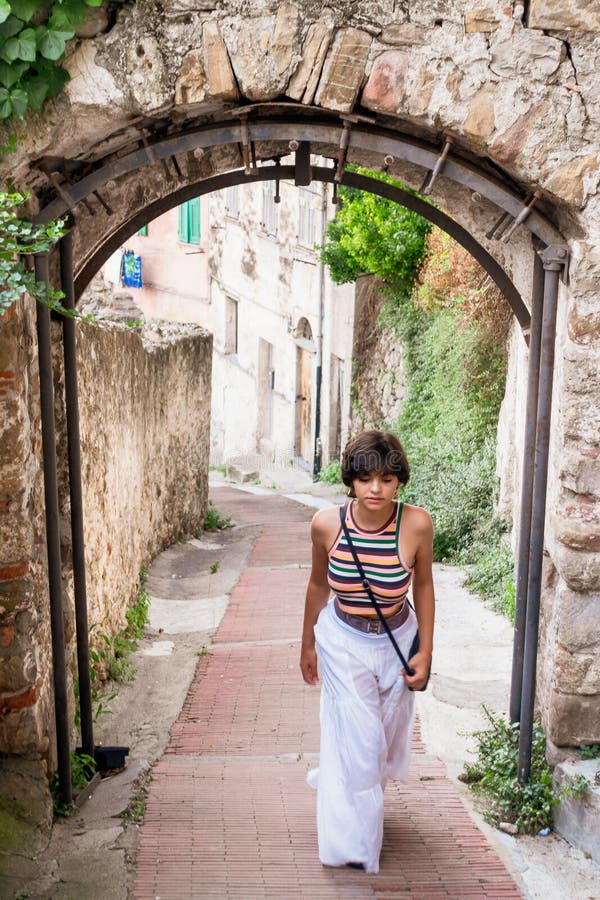 Girl walking downhill  street in Ventimiglia