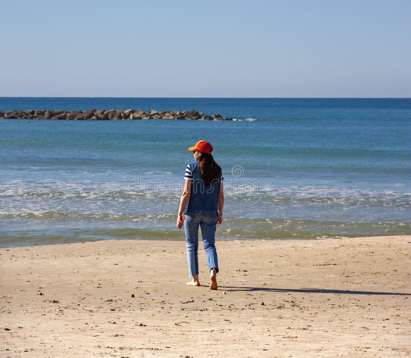 Girl Walking To the Water`s Edge of the Sea Stock Photo - Image of ...