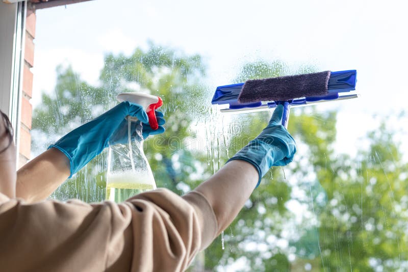 The Girl Washes the Windows Using a Window Washing Device. Window