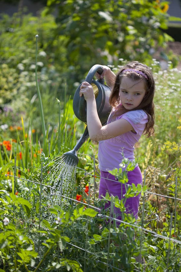 Girl Watering the Garden stock photo. Image of flora 26139208