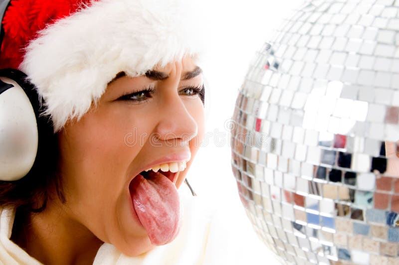 Girl wearing christmas hat and with tongue out