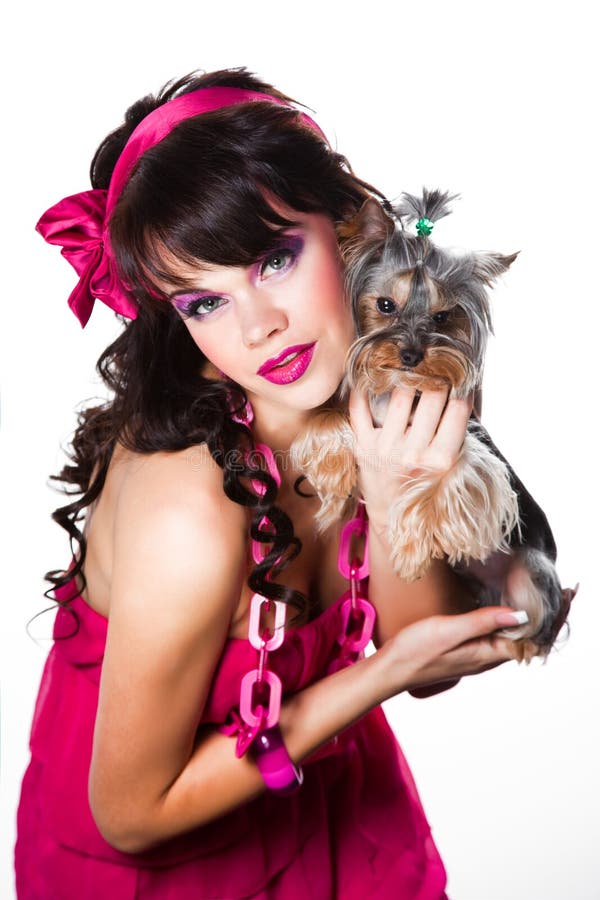 Girl wearing pink with small yorkshire terrier