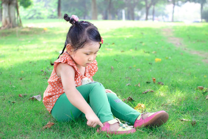 Girl wearing shoes on the lawn