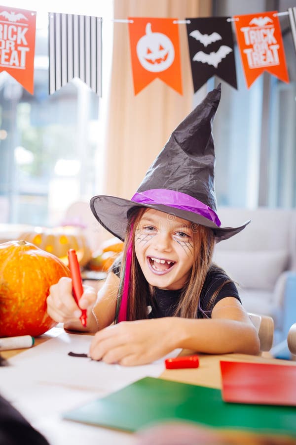 Girl Wearing Wizard Halloween Costume Laughing while Drawing Scary ...