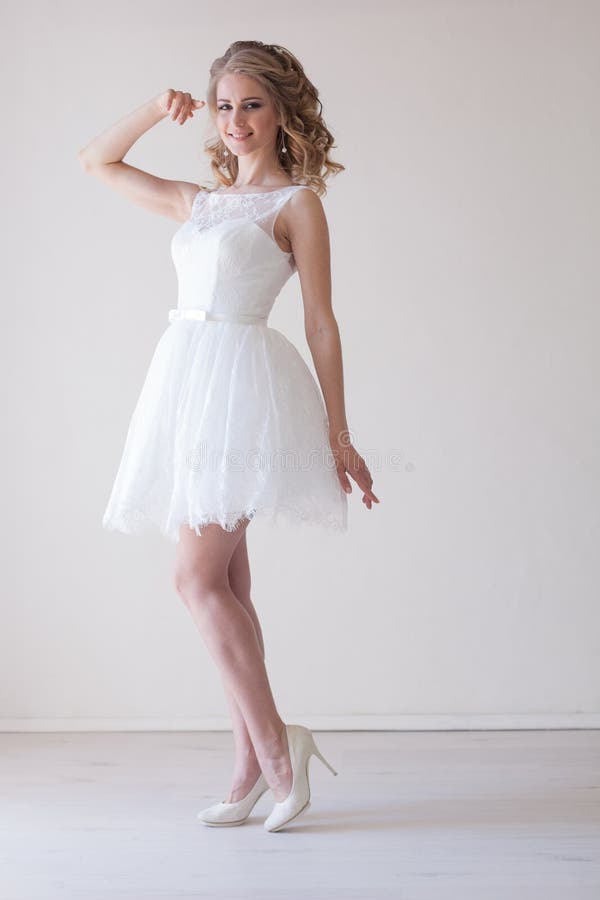 Girl in a Wedding Dress Stands in a White Room Wedding Stock Photo ...