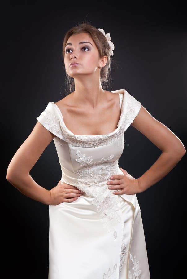 Girl in a wedding dress in the studio